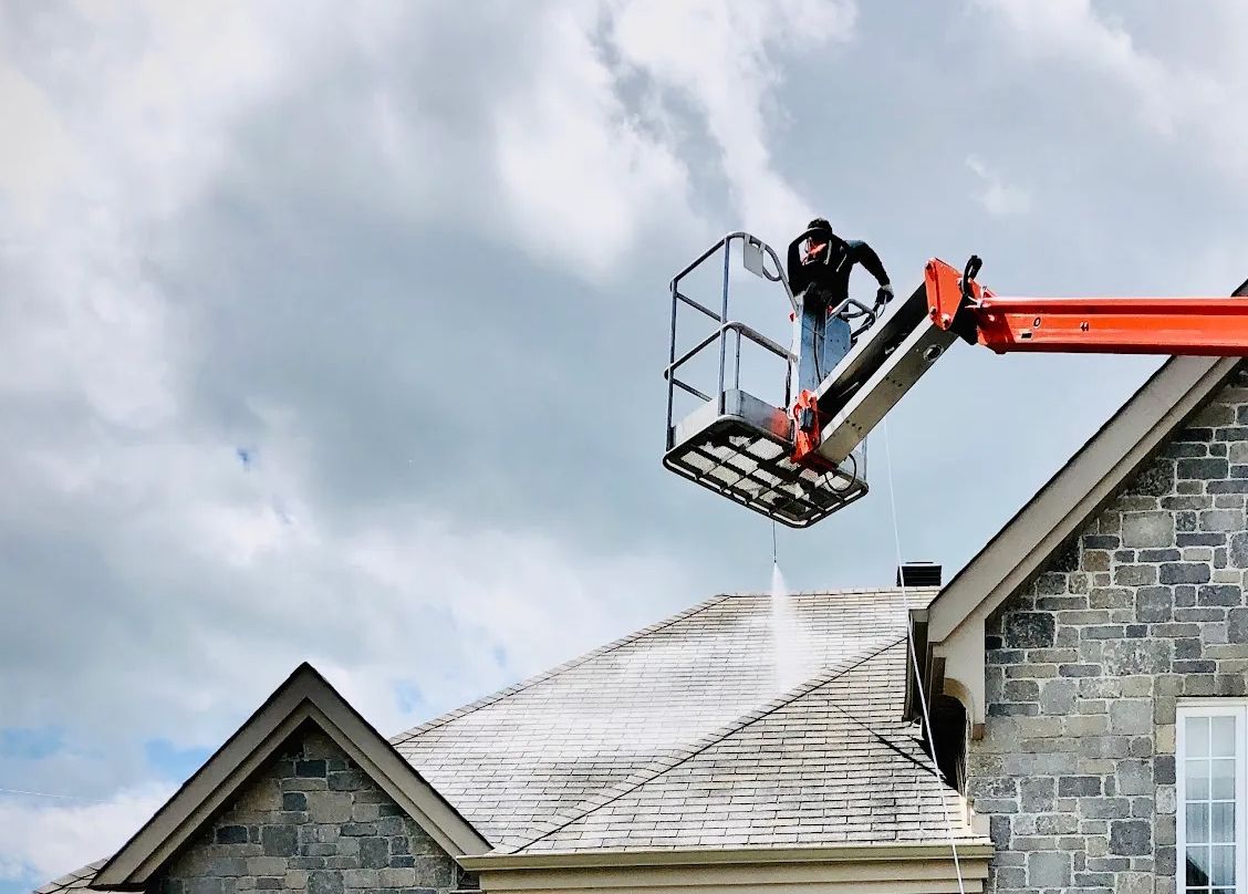 202503 gonano roof coating 3 Integro low angle of a roofer spraying on GoNano roof coating