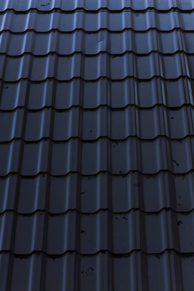 closeup of metal roofing tiles installed instead of asphalt shingles